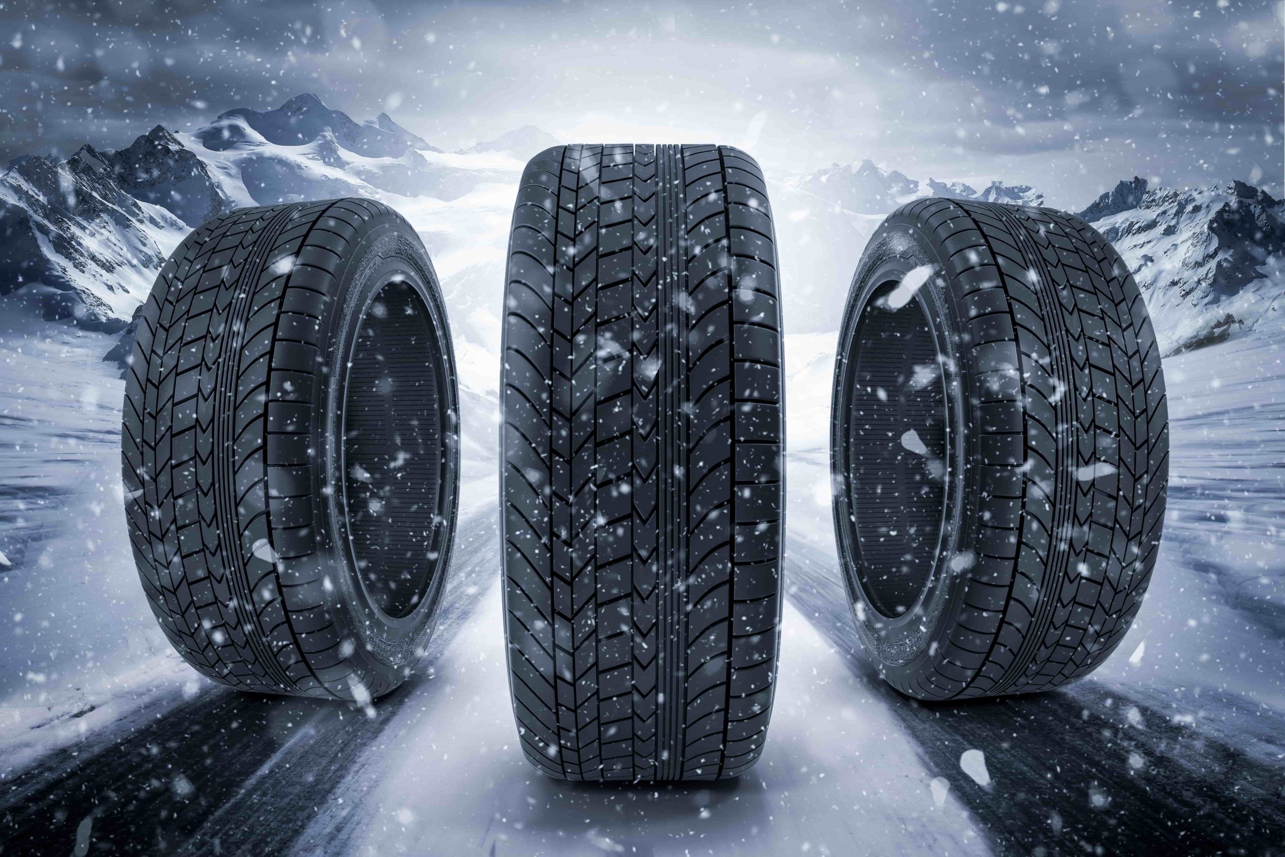 An image of three winter tires surrounded by heavy snow