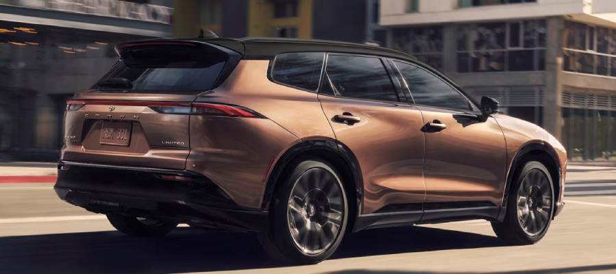 A gold 2026 Toyota Crown Signia speeds through the city. New 2026 Toyota Crown Signia for sale at Heffner Toyota in Kitchener, ON